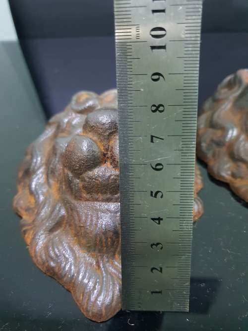 TWO SOLID CAST IRON LION HEADS....HEAVY METAL