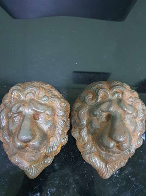 TWO SOLID CAST IRON LION HEADS....HEAVY METAL