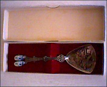 Beautiful boxed unused sugar spoon with a relief in the bowl and CHINA clogs on the handle