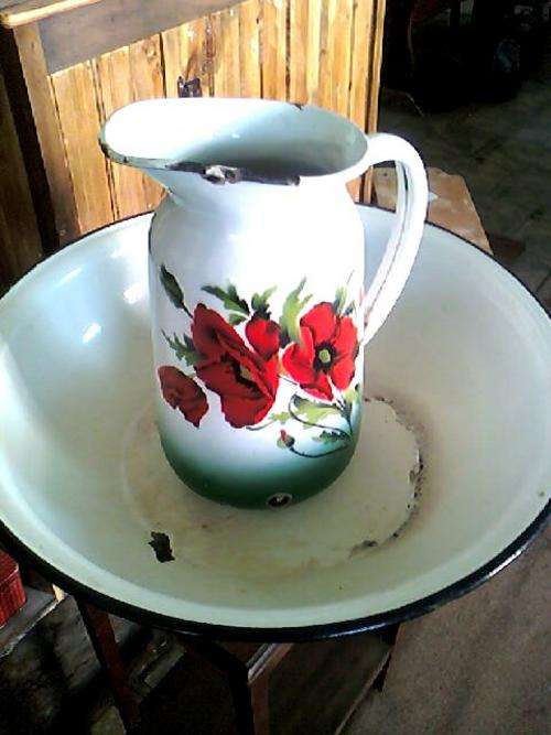 ENAMEL JUG AND BASIN WITH GREEN EDGING ,WHITE OVERALL WITH  RED FLORAL DESIGN