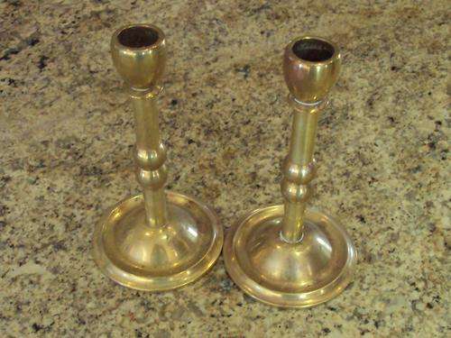 A PAIR OF BRASS CANDLESTICKS