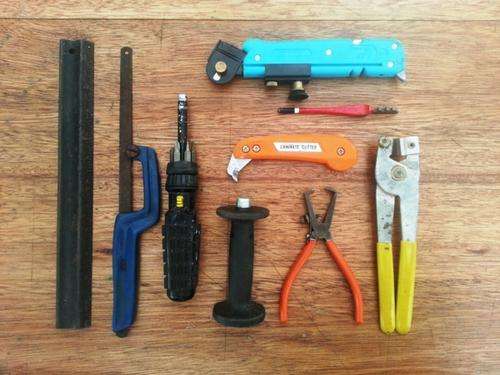 Glass, Tile and Laminate cutters, ratchet screw driver, wire strippers and an assortment of tools