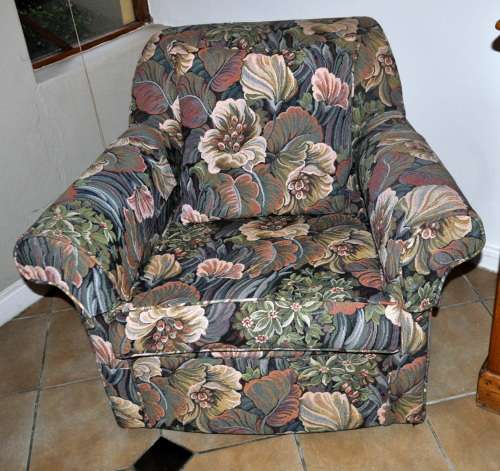 Pair of upholstered arm chairs in floral fabric.