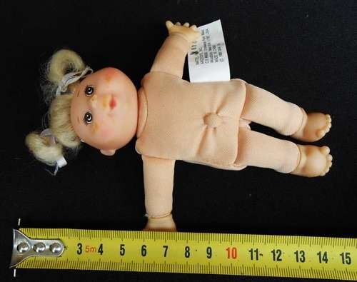 collectable Tiny Cabbage Patch doll with blond pigtails and brown eyes