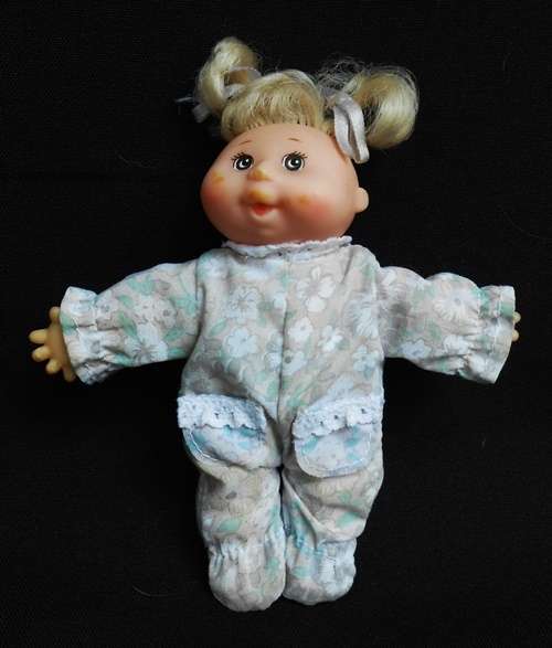 collectable Tiny Cabbage Patch doll with blond pigtails and brown eyes