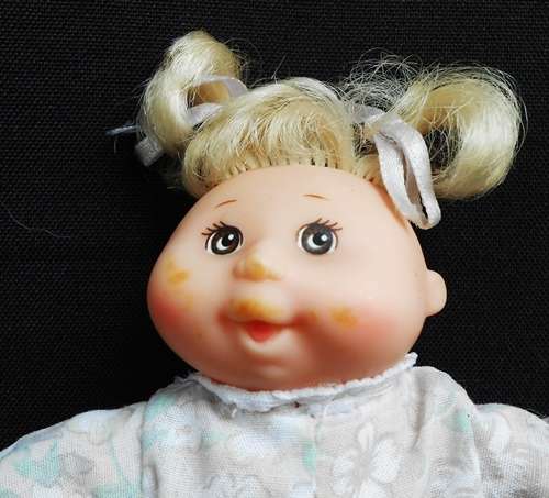 collectable Tiny Cabbage Patch doll with blond pigtails and brown eyes