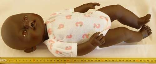 Black baby doll same size as Zapf Baby Born doll no markings