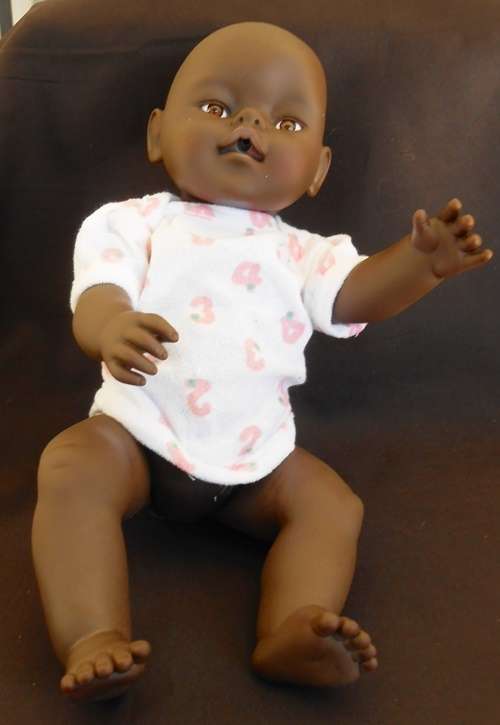Black baby doll same size as Zapf Baby Born doll no markings