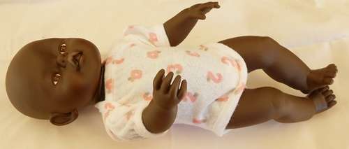 Black baby doll same size as Zapf Baby Born doll no markings
