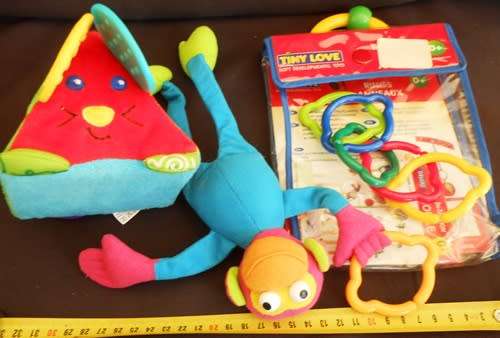 Colourful toys for small babies made by TINYLOVE to hook on crib or carriage