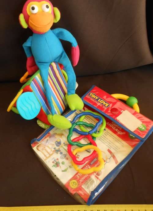 Colourful toys for small babies made by TINYLOVE to hook on crib or carriage