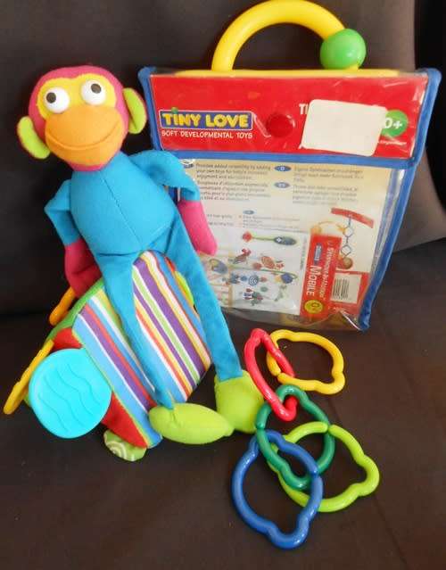 Colourful toys for small babies made by TINYLOVE to hook on crib or carriage