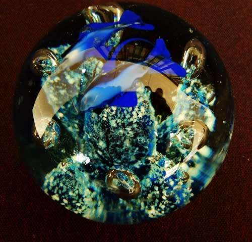 glass paperweight with blue fishes swimming over blue coral