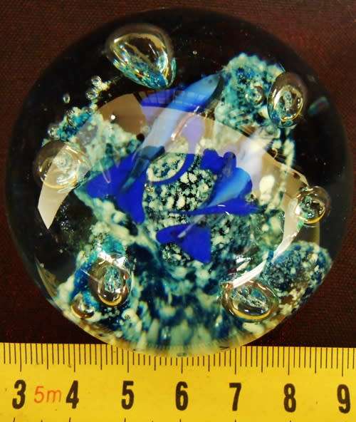 glass paperweight with blue fishes swimming over blue coral