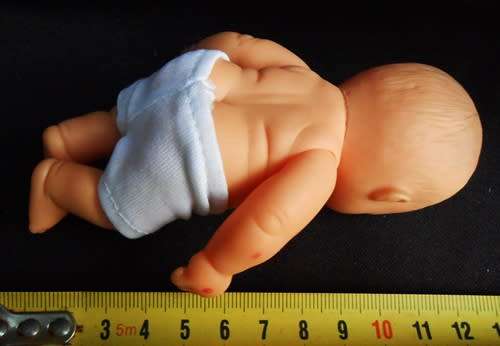 Small chubby baby doll looks like Berenguer doll with pouting face and blue eyes