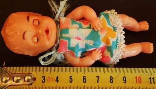 Vintage small hard plastic doll in original dress made in hong kong