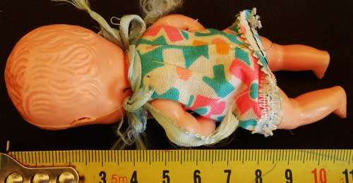 Vintage small hard plastic doll in original dress made in hong kong