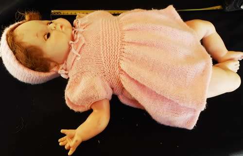 Vintage Collectable Soft bodied Baby doll in knitted dress.