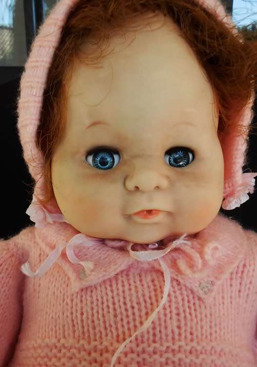 Vintage Collectable Soft bodied Baby doll in knitted dress.