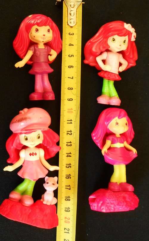 four collectible Strawberry Shortcake figures