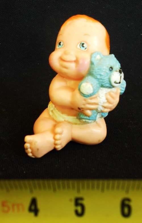 collectible small Diaper Baby doll with a blue teddy