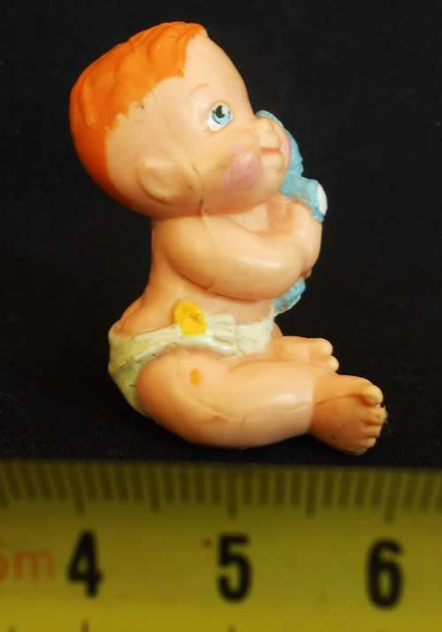 collectible small Diaper Baby doll with a blue teddy