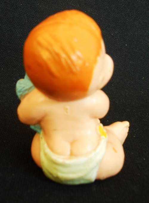 collectible small Diaper Baby doll with a blue teddy