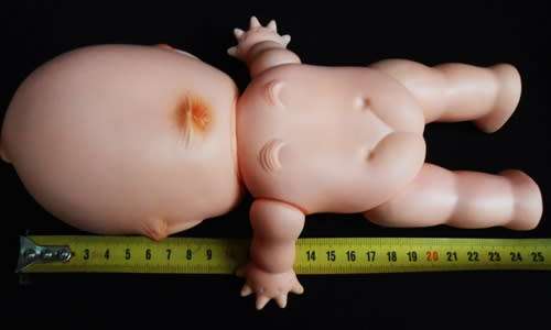 vintage Kewpie doll with brown eyes and wings