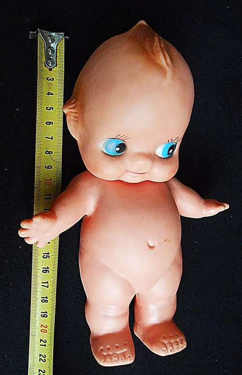 collectible small Kewpie doll with blue eyes and blunt fingers