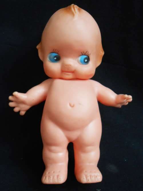 collectible small Kewpie doll with blue eyes and blunt fingers