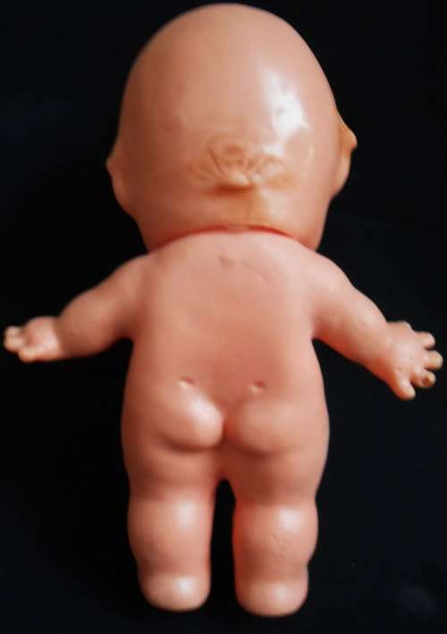 collectible small Kewpie doll with blue eyes and blunt fingers