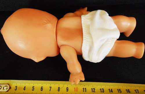 Vintage small kewpie doll  in white pants