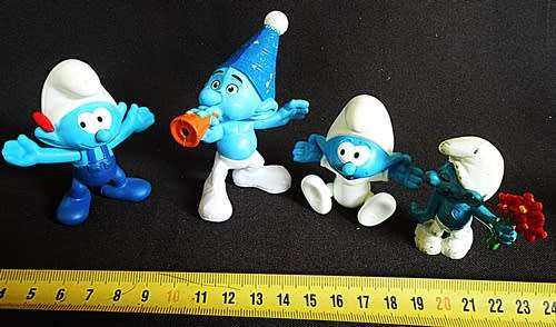 four collectible smurf figures