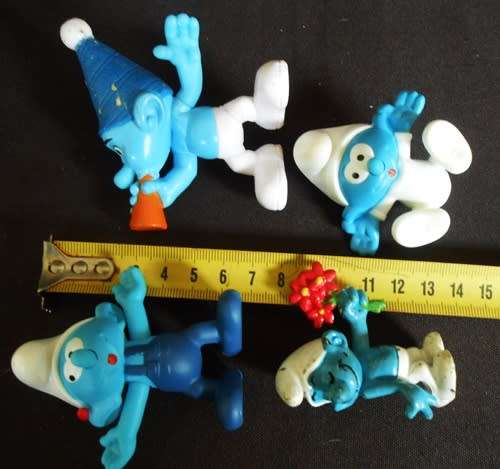 four collectible smurf figures