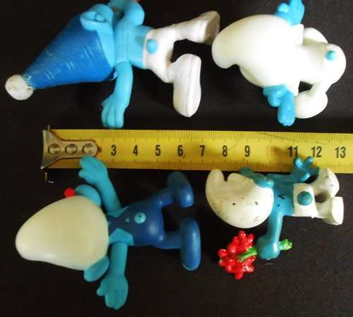 four collectible smurf figures
