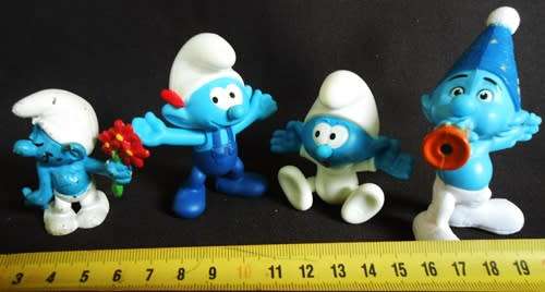 four collectible smurf figures