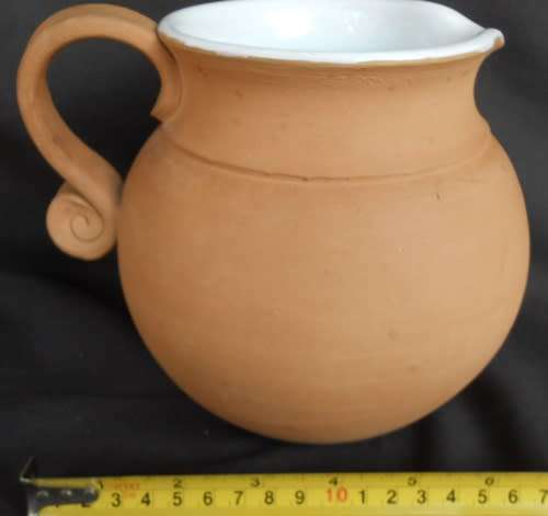 Beautiful classic shape terracotta jug with white glaze inside from Italy
