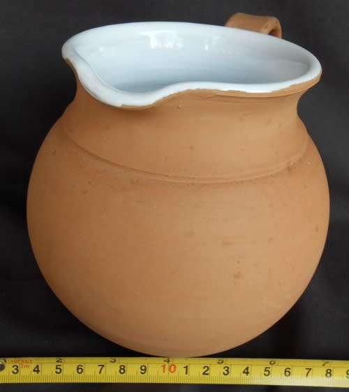 Beautiful classic shape terracotta jug with white glaze inside from Italy