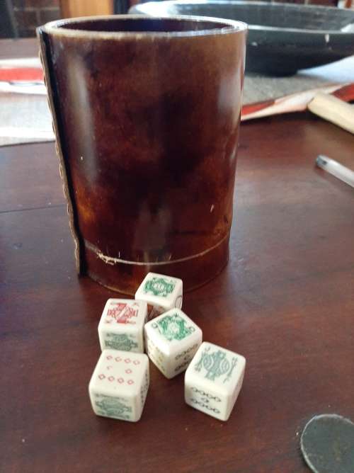 Poker dice in leather cup
