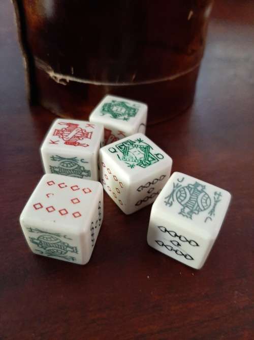 Poker dice in leather cup