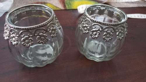 Glass jars with metal collars tea candle holders