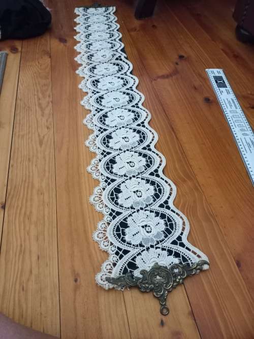 Vintage lace cloth with brass hanging