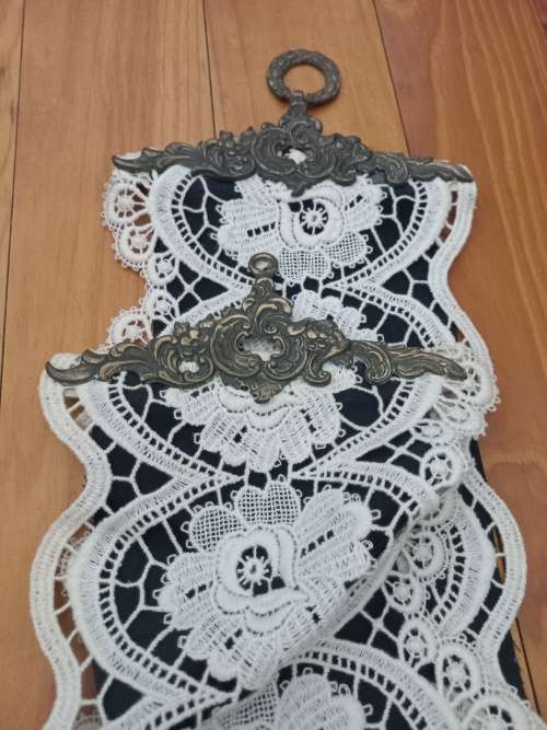 Vintage lace cloth with brass hanging