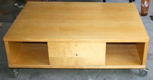 A STUNNING LARGE VERY HEAVY COFFEE TABLE ON WHEELS WITH TO LARGE DRAWERS WITH LOTS OF STORAGE SPACE