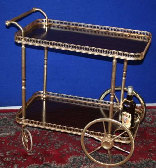 A French retro brass metal drinks trolley, the 2 tiers with shaped and pierced galleries.