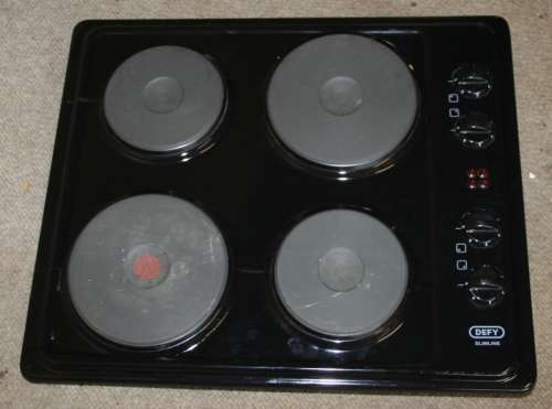 A BLACK DEFY SLIMLINE FOUR PLATE HOB RELATIVELY NEW - IN GOOD CONDITION
