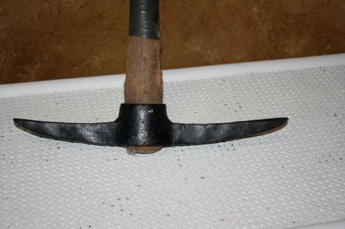 A Primitive Farmhouse Hand Forged Pick Ax. Very traditional, historic farm implement