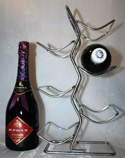 Here is a great, vintage, 5 bottle wine rack made out of Stainless steel. Stunning