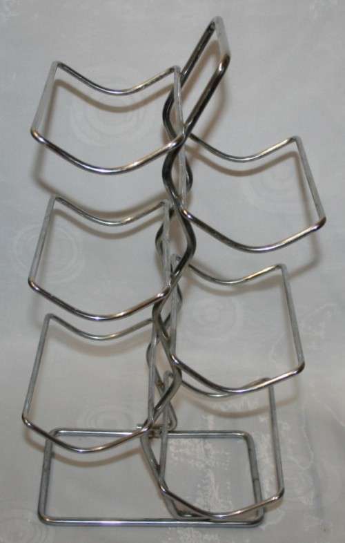 Here is a great, vintage, 5 bottle wine rack made out of Stainless steel. Stunning