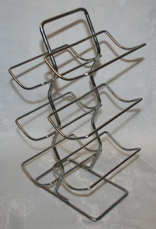 Here is a great, vintage, 5 bottle wine rack made out of Stainless steel. Stunning